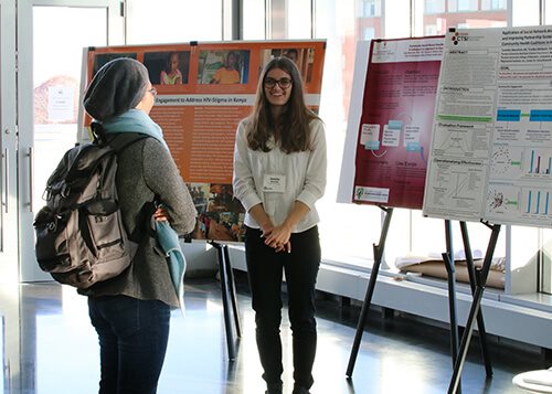 IUPUI Students having a conversation in the Campus Center about their research. 
